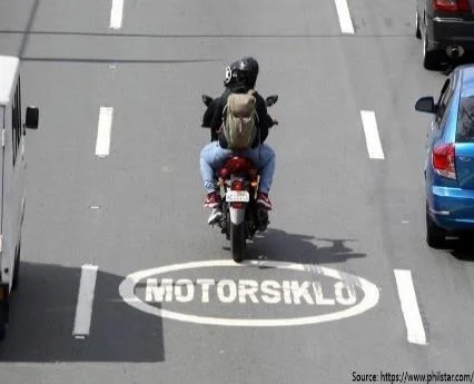 a pavement marking designating motorcycle lanes, shared with other vehicles.